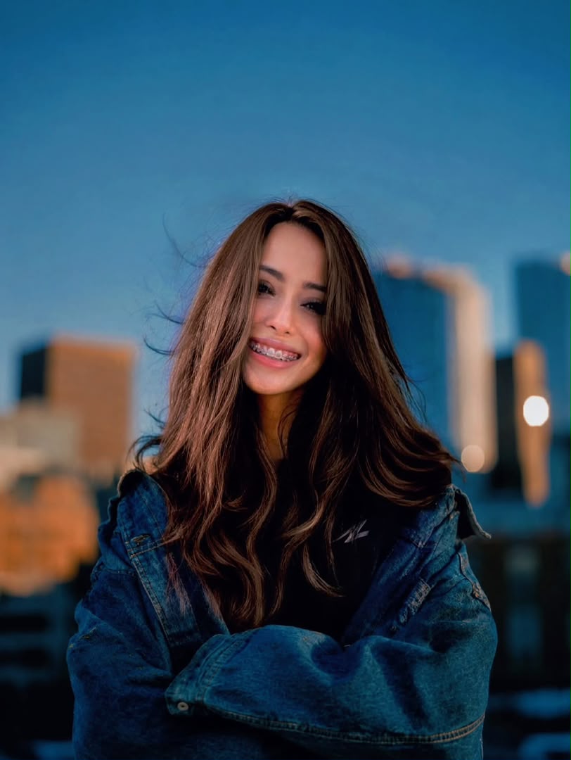 Profile photo of Asya Kamaruddin, Creative Director at Zaramiz Sdn Bhd, smiling outdoors against a soft-focus city backdrop.